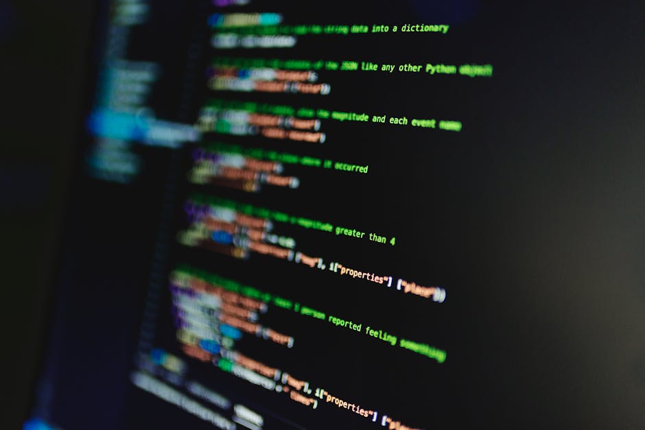 A close-up view of a computer screen displaying colorful lines of programming code, including keywords, variables, and functions in various hues such as red, green, blue, yellow, and white. The code a